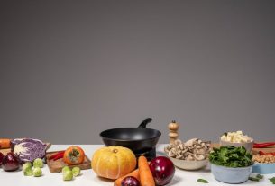 Studio composition of fresh vegetables and a frying pan, ideal for healthy cooking and recipe preparation.